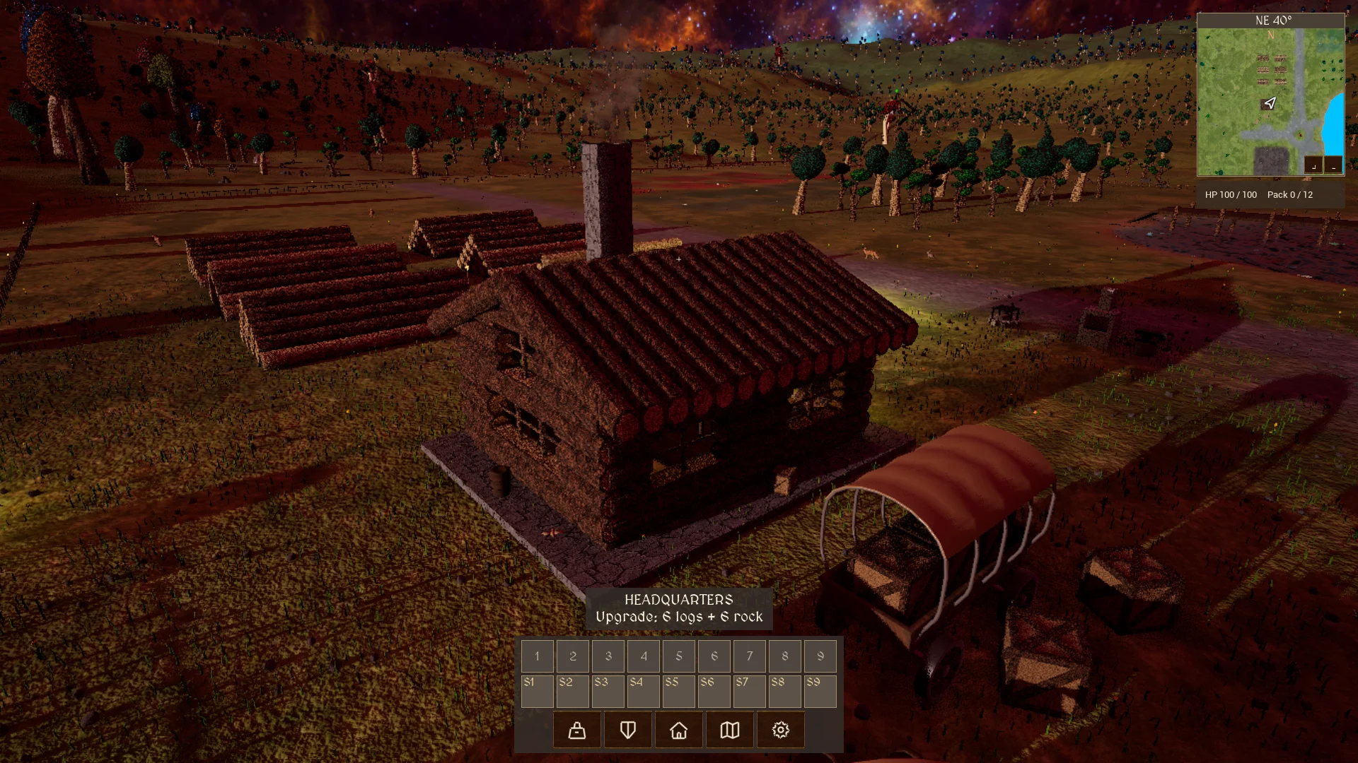 The development village headquarters beside a wagon and log storage